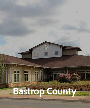 Charming rural scene in Bastrop County with a country home and Texas flag, representing the county's small-town charm.
