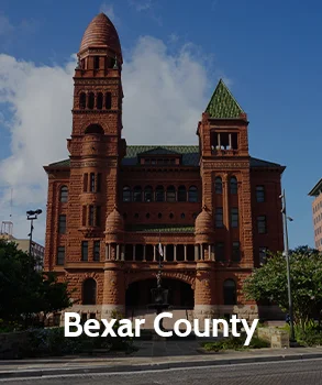 Historic Bexar County Courthouse with red sandstone towers and arches in downtown San Antonio, representing Bexar County and access to Bexar County court records.