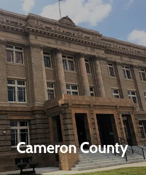 Historic Cameron County courthouse with classical stone architecture, representing Cameron County and access to county court records and legal services.