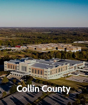 Aerial view of the modern Collin County courthouse surrounded by trees and suburban development, representing Collin County and access to Collin County court records