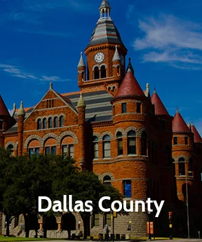 Historic Dallas County courthouse with its red sandstone architecture and tall clock tower, representing Dallas County and access to Dallas County court records and the Dallas County appraisal district.