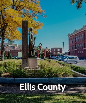 Statue in Ellis County with colorful autumn trees in the background, representing Ellis County’s historical landmarks and public spaces.