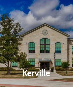 Kerrville city hall with its architectural elegance, surrounded by Texas hill country, highlighting the growing concern for property taxes as the area develops.
