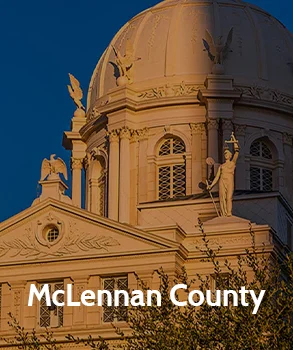 Close-up of the McLennan County courthouse with its ornate dome and sculptures, representing McLennan County’s historic architecture and legal center.