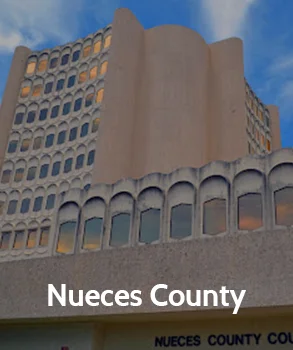 Nueces County courthouse with its modern architectural design, featuring curved walls and large windows, representing Nueces County's legal services.