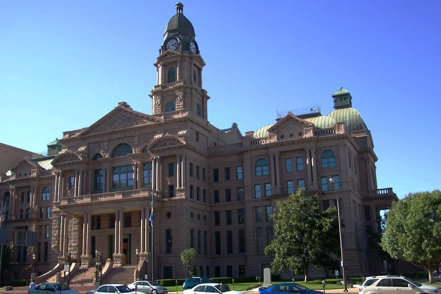 Tarrant County Courthouse in Fort Worth, featuring stunning historic architecture and a prominent clock tower, representing property tax protest services by Tax Cutter.