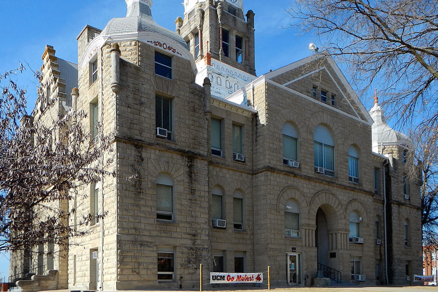 Johnson County Courthouse with historic stone architecture and clock tower, symbolizing Tax Cutter’s professional property tax protest services for homeowners in Johnson County, Texas.