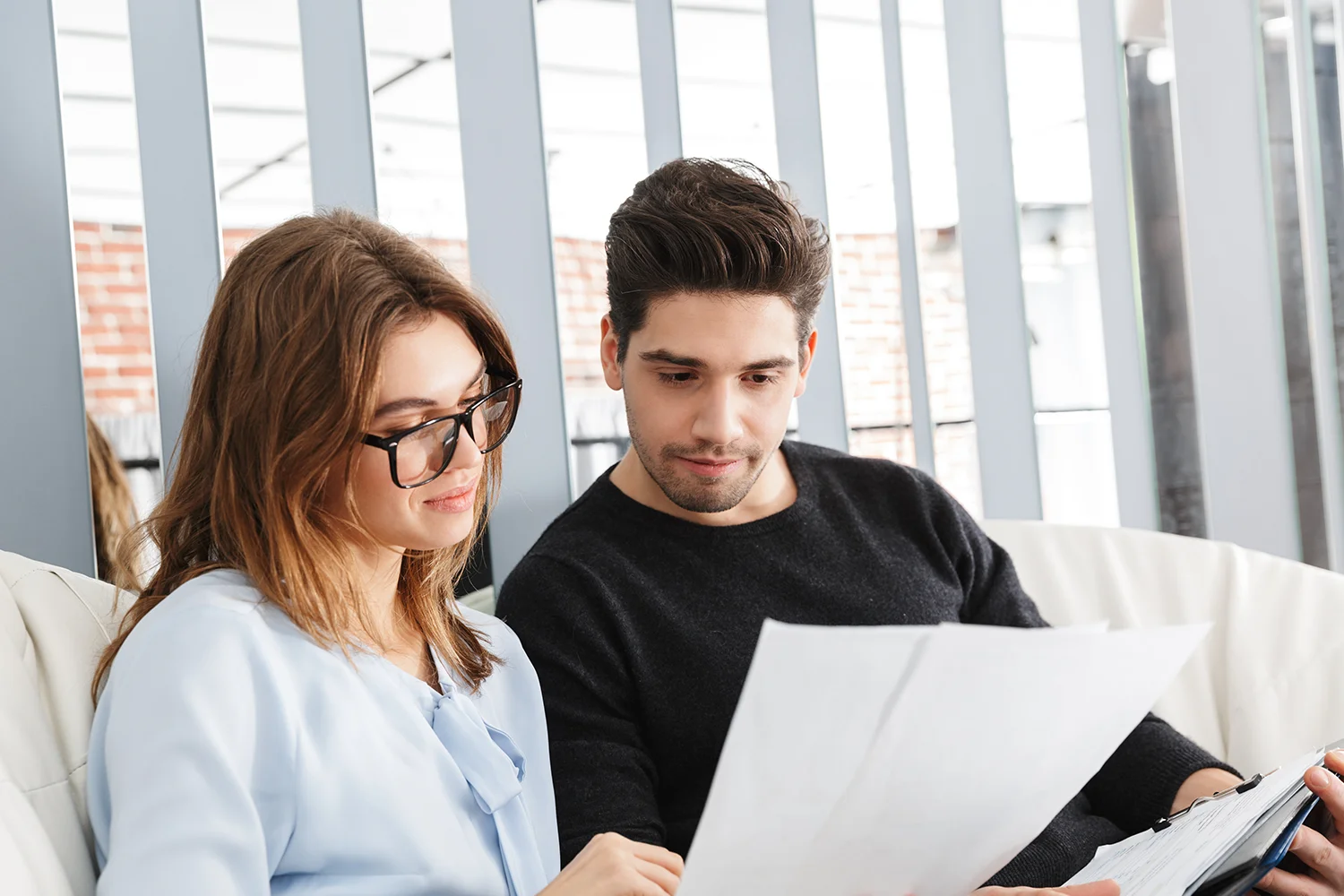 Homeowners reviewing property tax documents together, representing professional property tax protest services by Tax Cutter.